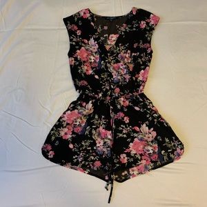 Floral and black romper. V cut, synched waist 
Size M